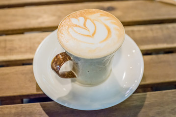 Cup of coffee latte art on wood table