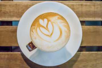 Cup of coffee latte art on wood table