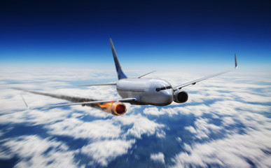 Fototapeta na wymiar Airplane flying in sky with engine on fire