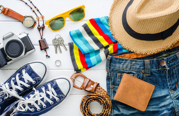 Travel accessories and costume on white background