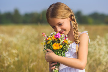 Cheerful kid enjoying nature on field