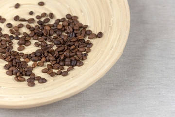 Coffee beans on wooden plate. Top view.