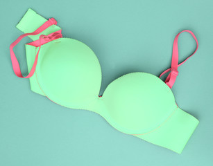 Summer concept, Blue bra on blue background. (Pop art style)