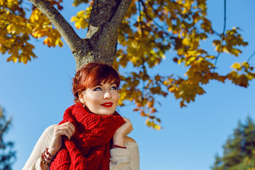 Beautiful girl standing outdoors near autumn tree