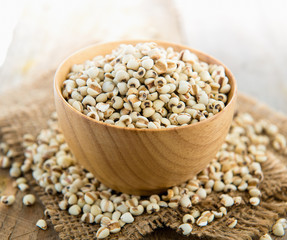 Millet the organic grain food in wood bowl on wood table