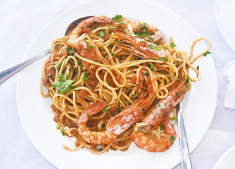 mediterranean seafood - pasta with shrimps at a greek tavern