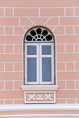 Vintage window on a polished stone wall.