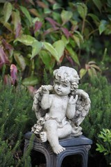 Fototapeta na wymiar Kleiner Engel auf Grab im frühen Herbst