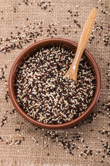 clay bowl with white, black and red quinoa