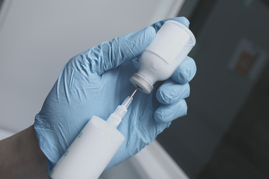 Male nurse filling the syringe