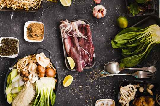 Raw squid with healthy raw ingredients and seeds.