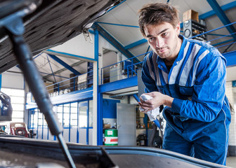 Car mechanic under the hood