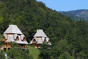 Fototapeta na wymiar wooden cottages on mountain landscape