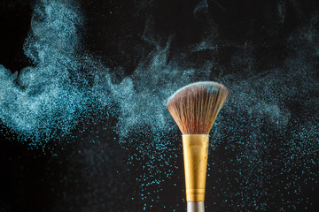 Brush with blue shadows on black background