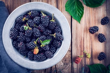 juicy fresh organic blackberries in old bowl