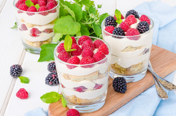 Tiramisu in a glass with coffee sponge cake and fresh berries
