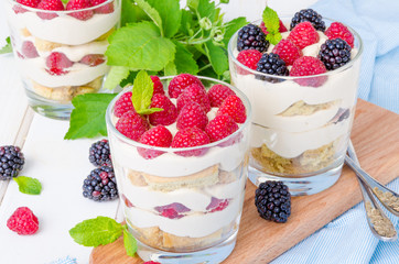 Tiramisu in a glass with coffee sponge cake and fresh berries