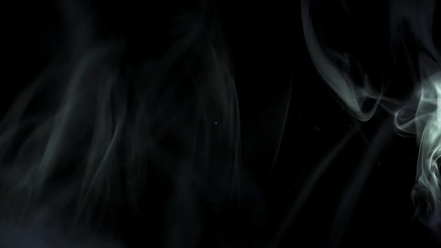 3 in ! The stream of thick smoke on a dark background. Slow motion capture