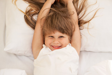 Fototapeta premium Toddler girl laying on bed