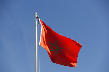 Naklejka na ściany i meble National flag of Morocco on a flagpole