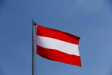 Fototapeta na wymiar National flag of Austria on a flagpole