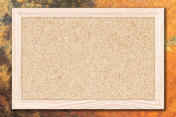 Cork board or Empty bulletin board with a wooden frame on cement wall background with copy space...