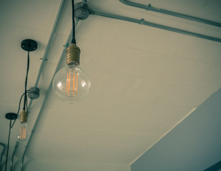 Edison's light bulb and lamp in modern style. Warm tone light bulb lamp. Lamps in coffee shop. 
