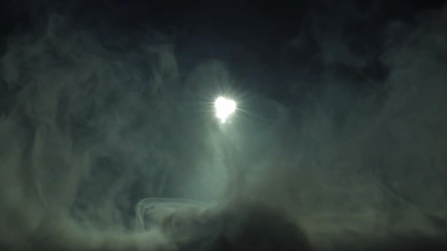 The moolight on the background of thick smoke. Slow motion capture.