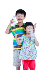 Two asian boy and girl drinking milk, isolated on white. 