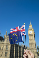 Fototapeta na wymiar European Union and British Union Jack flag flying in front of Big Ben and the Houses of Parliament at Westminster Palace, London, symbols of the Brexit EU referendum