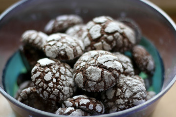 Chocolate crackle cookies in a bowl. Decorated with granulated and powdered sugar. Selective focus.