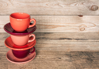 set of colorful cups and dishes and dessert