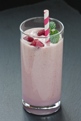Glass fresh raspberry milkshake / Delicious fresh raspberry milkshake or yogurt on dark background