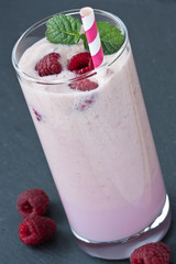 Glass fresh raspberry milkshake / Delicious fresh raspberry milkshake or yogurt on dark background