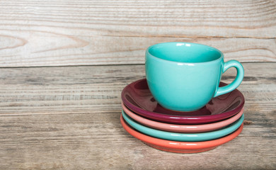 set of colorful cups and dishes and dessert