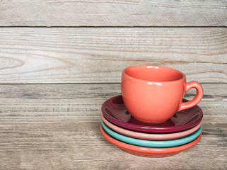 set of colorful cups and dishes and dessert
