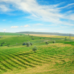 Hilly terrain with a terrace and a blue sky