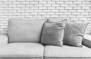 Grey linen sofa couch chair on white brick wall background