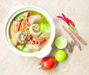 Oxtail soup in white dish on brown tablecloth/ Halal food