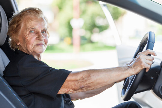Elderly woman behind the steering wheel