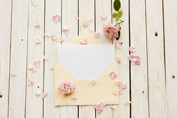 Two envelope with a card inside, old pocket watch and a rose lyi