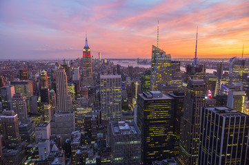 Bright golden pink sunset view of the Midtown Manhattan New York City skyline looking south 