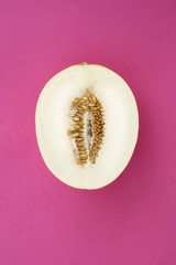 Single yellow melon on purple background