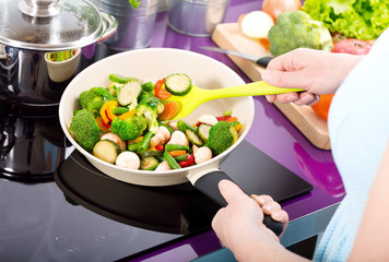 Woman prepare fried vegetables