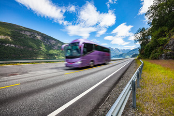 Tourist bus traveling on the road in Norway