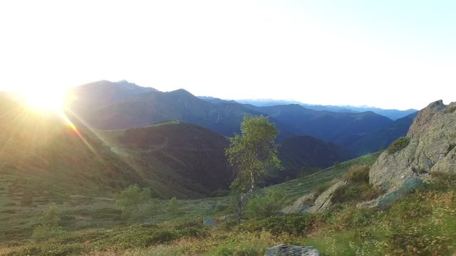 hiking, walking, trekking outdoors on mountain trail path in sunny day at sunset, 4k side view pov (point of view)