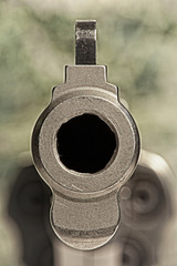 Looking down the barrel of a .357 Magnum stainless steel revolver loaded with hollow point...