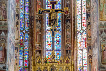 Jesus Christ on the cross, crucifix with stained glass windows 