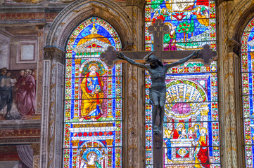 Fototapeta na wymiar Jesus Christ on the cross, crucifix with stained glass windows 