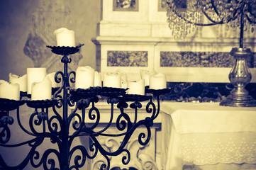 Iron candelabra in a church, artistic sepia edit with copy space
